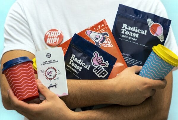 a man holding a cup of coffee and some snacks