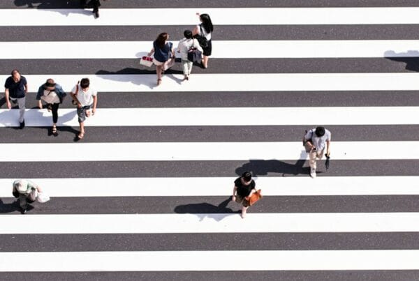 aerial view photography of group of people walking on gray and white pedestrian lane