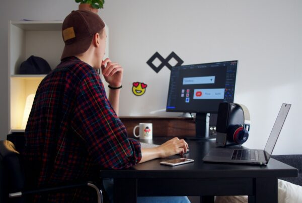 man sitting near table using computer